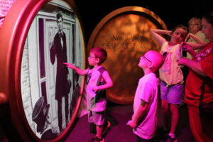 A family engaging with custom-made exhibits highlighting key moments in Abraham Lincoln's life