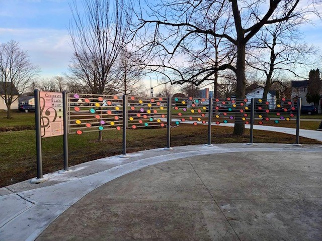 Exterior tribute sign in Skelton Park celebrating black music. The sign resembles sheet music.