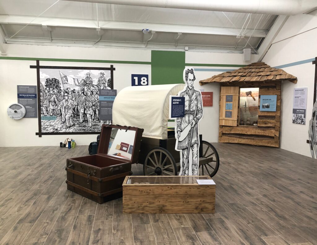 Custom exhibits for Fort Bend that show artifacts, images, and a re-created wagon.